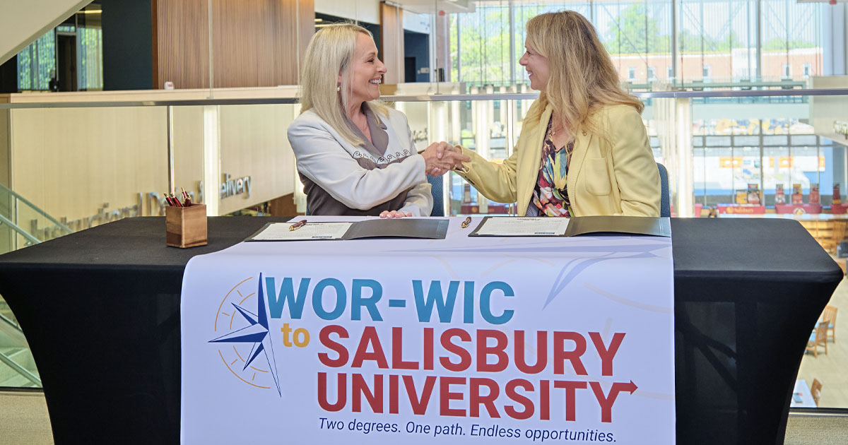 Wor-Wic Community College President Deborah Casey (left) and SU President Carolyn Ringer Lepre shake hands after signing a memorandum of understanding to create the 'Wor-Wic to SU' program through the Maryland Transfer Intensive.